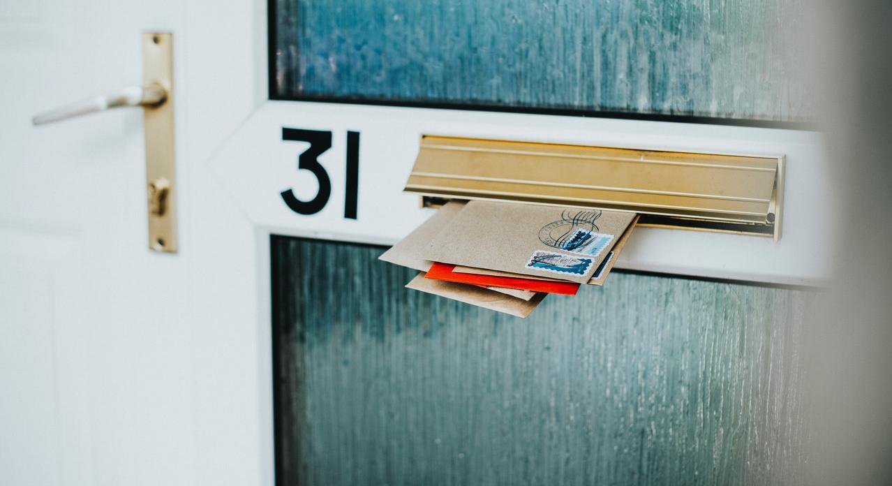 envelops in mail slot on door