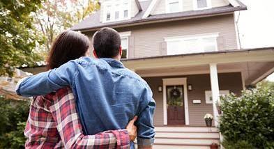 couple in front of house